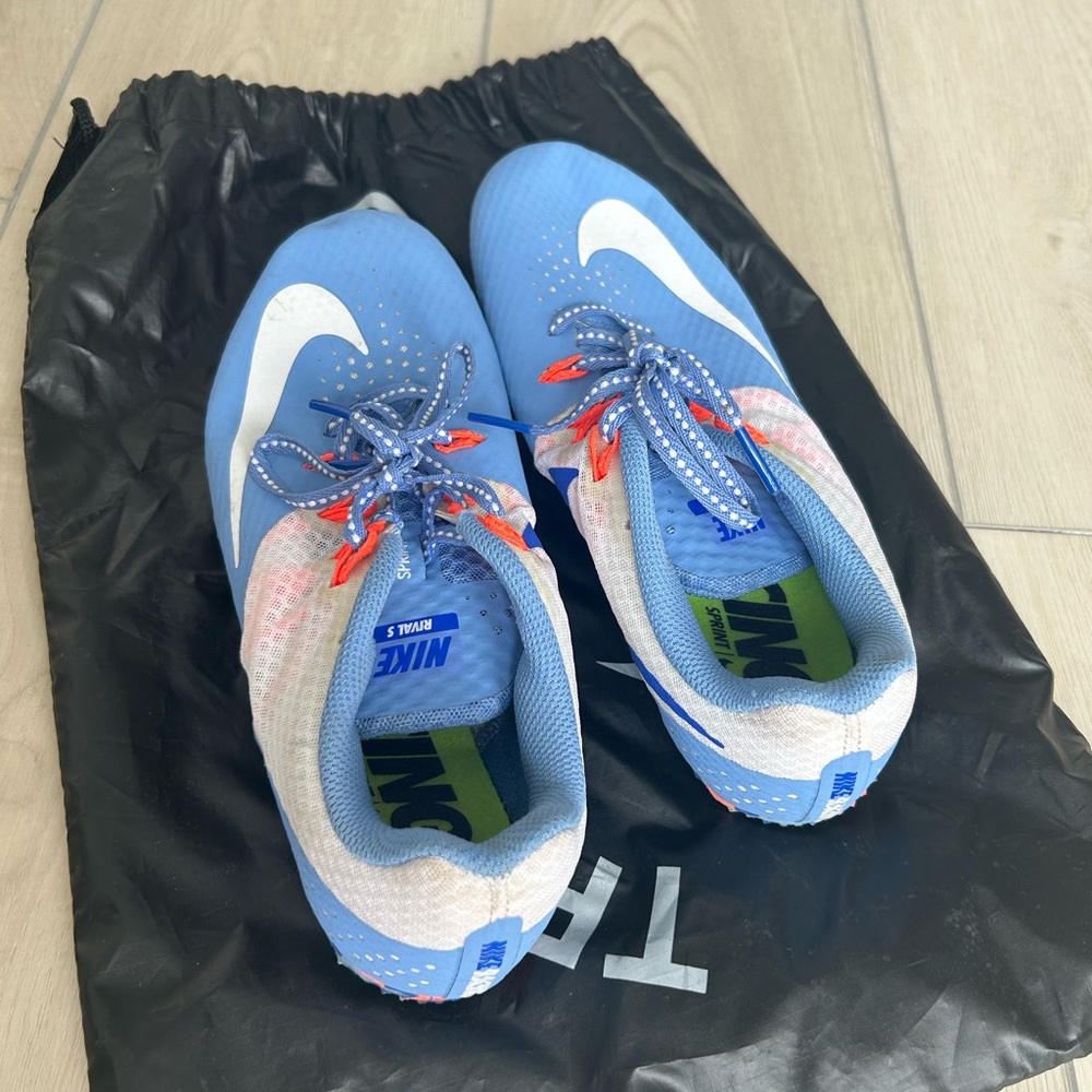 Nike Blue Track and Field cleats with White Swoosh and Orange Lace Accents